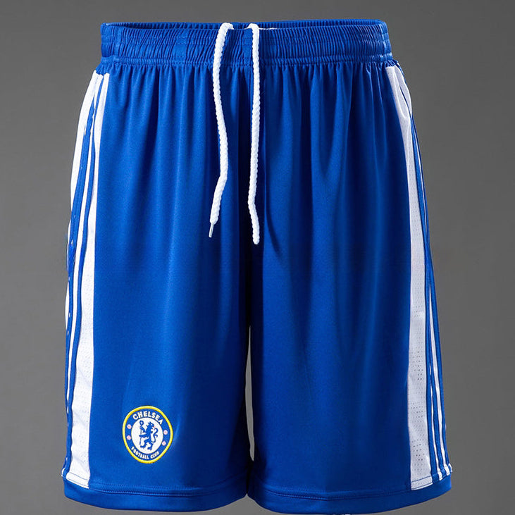 Blue athletic RETRO shorts with white side stripes and a Chelsea FC crest on the left leg, displayed on a mannequin against a gray background. 