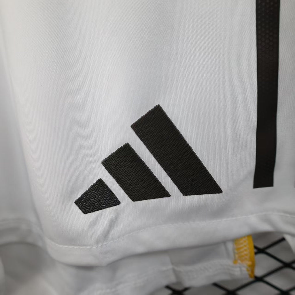 White shorts with black adidas-style triple-stripe logo on the thigh.