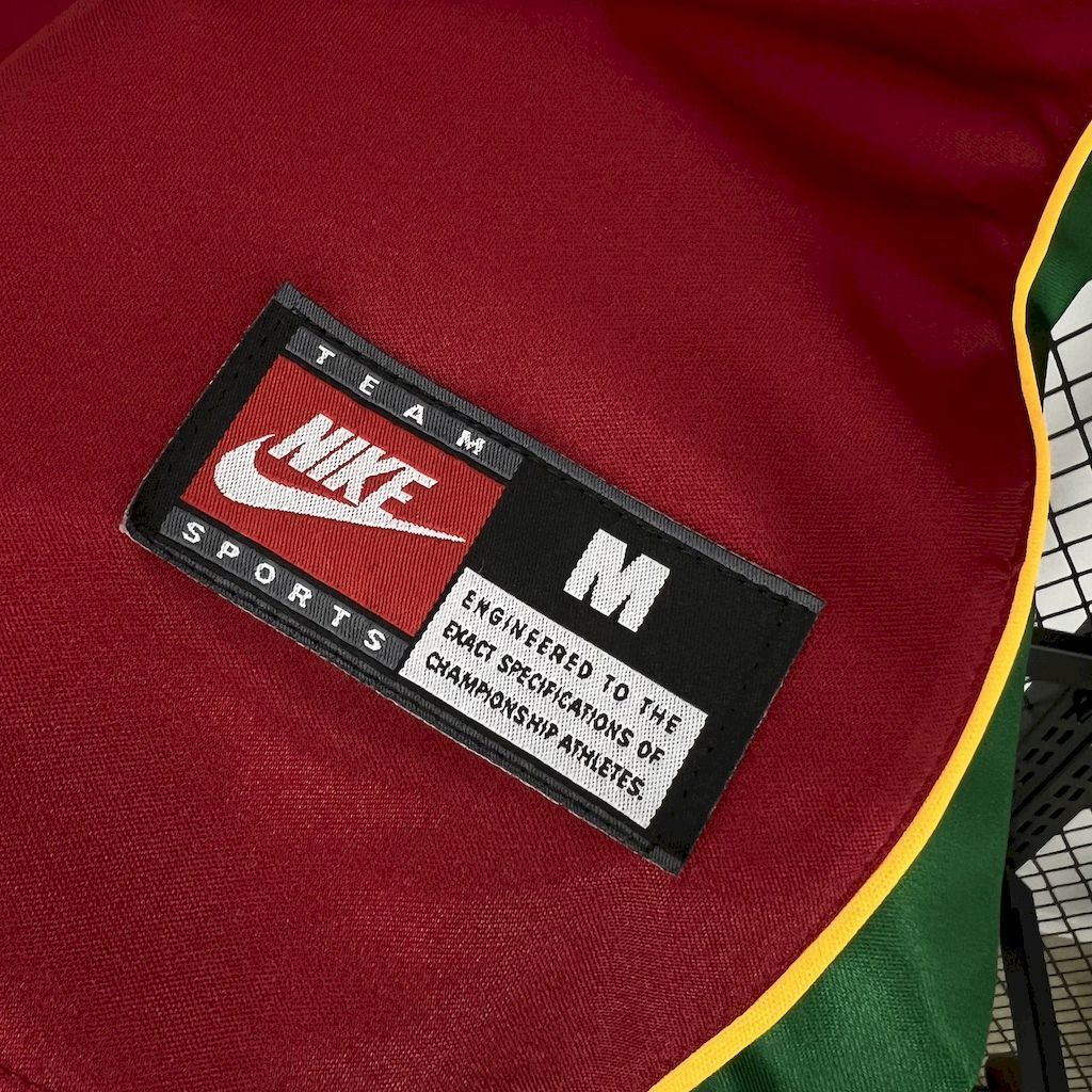 Jersey neck label with Nike branding and green/yellow trim
