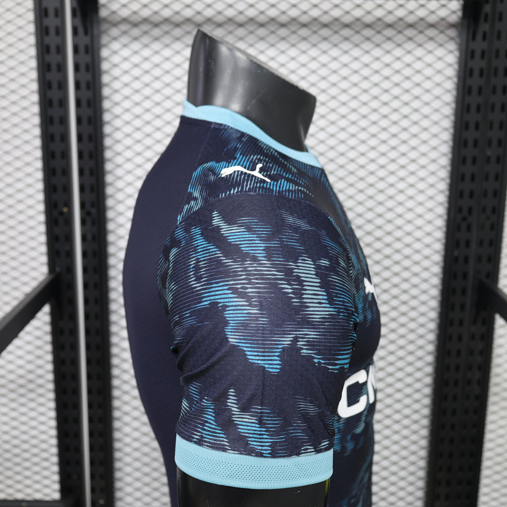 Side view of navy away jersey with light-blue collar and blue abstract pattern