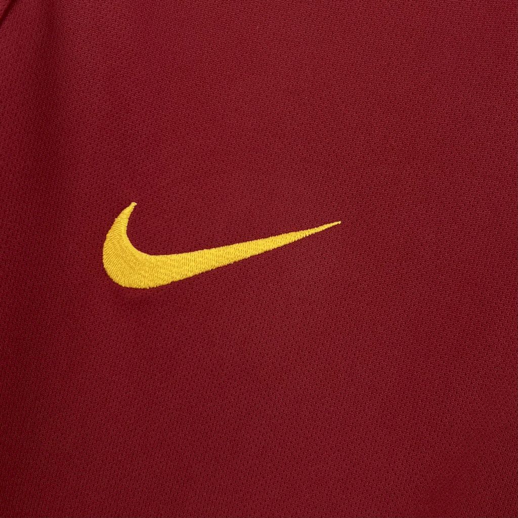 Maroon soccer jersey with yellow Nike swoosh logo on the chest