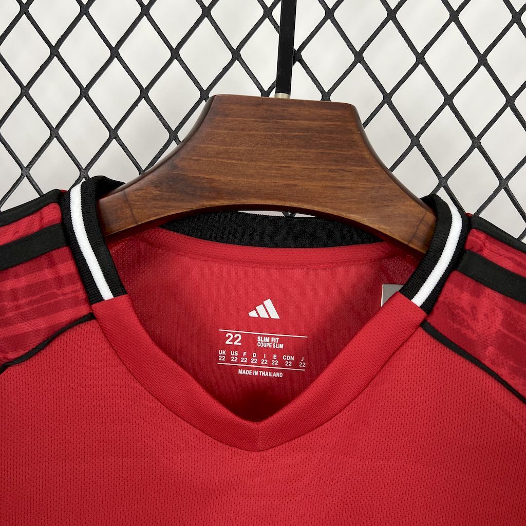 Kids red home football shirt collar close-up with adidas logo and size label inside neck