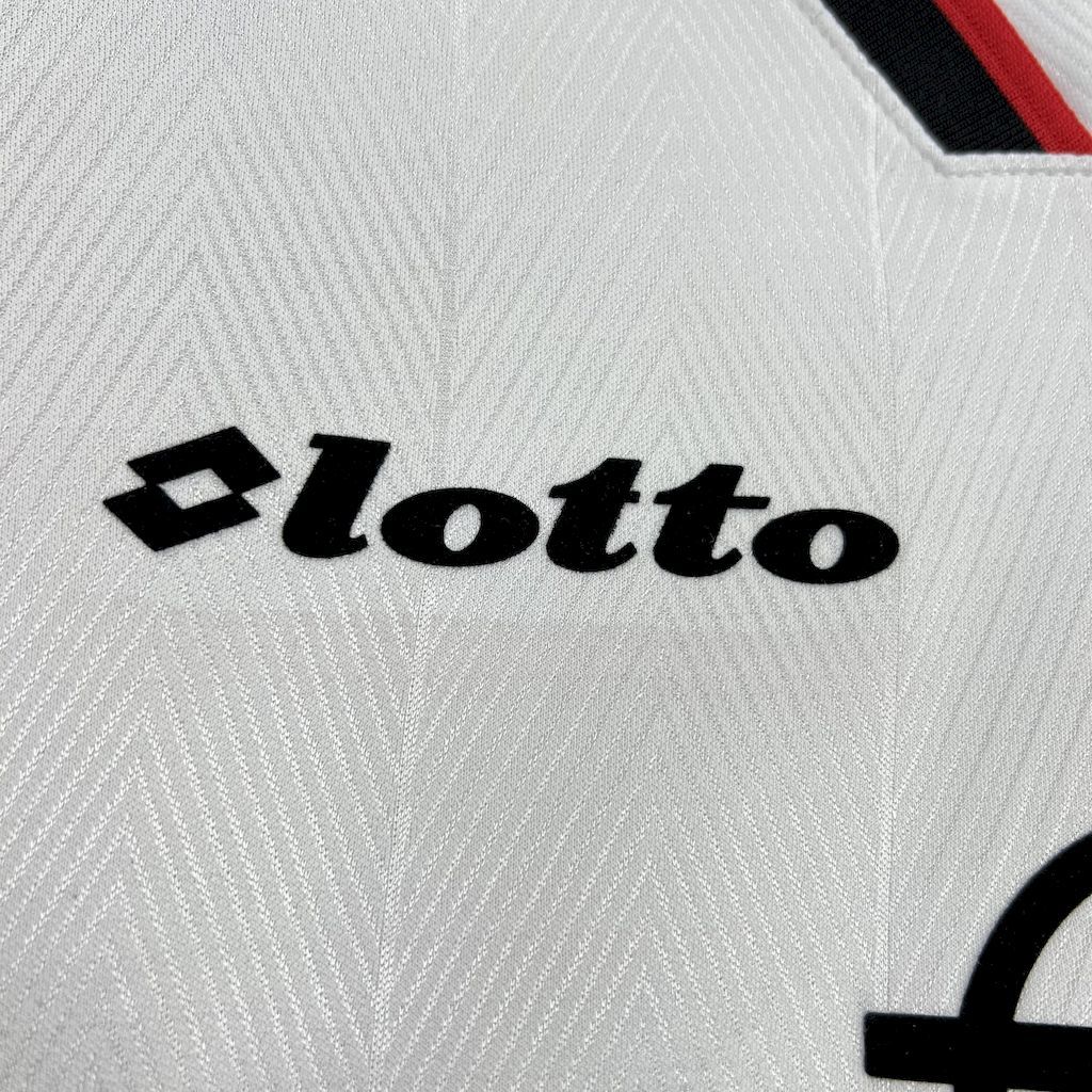 Lotto logo on white jersey fabric with subtle textured pattern