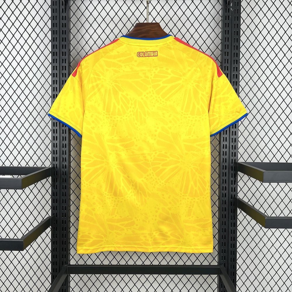 Yellow Colombia home soccer jersey back view, short sleeves, blue collar trim, red accents.