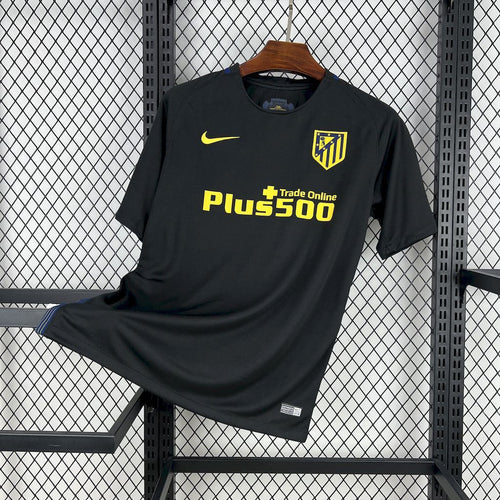 Black Atletico Madrid retro away football jersey with yellow Nike logo, crest, and Plus500 print