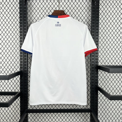 White soccer jersey back view with red-and-blue collar trim and small back text.