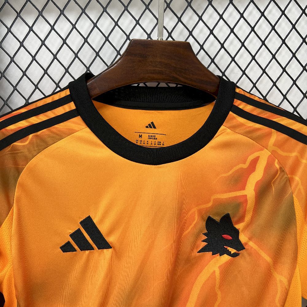 Orange soccer jersey close-up with adidas logo and black team crest