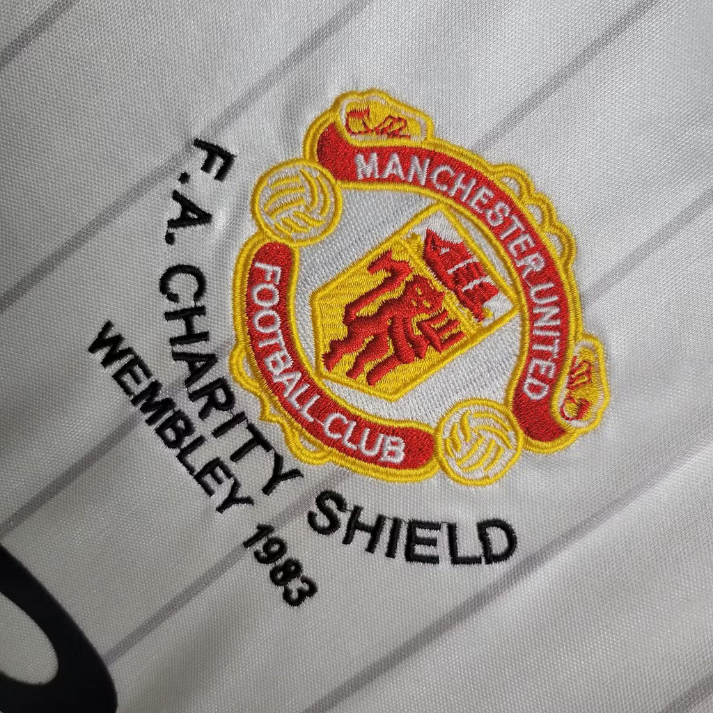 Manchester United crest and 'FA Charity Shield Wembley 1983' badge on white jersey
