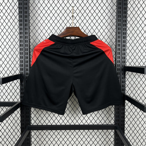 Black soccer fan shorts with red side stripes and elastic waistband
