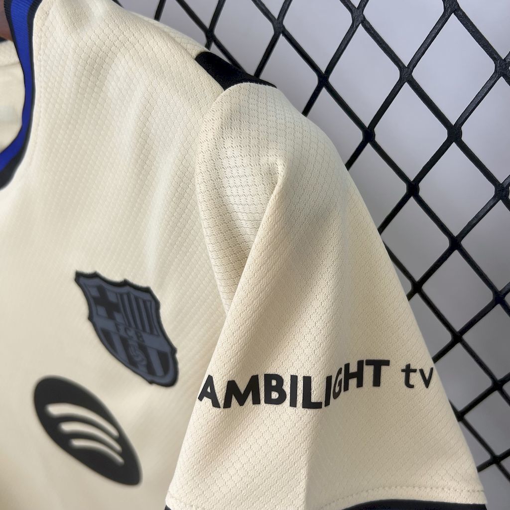 Cream jersey sleeve with navy club crest and sponsor text AMBILIGHT tv