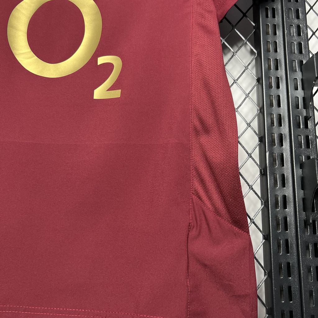 Maroon football jersey side panel with gold O2 number detail and curved hem