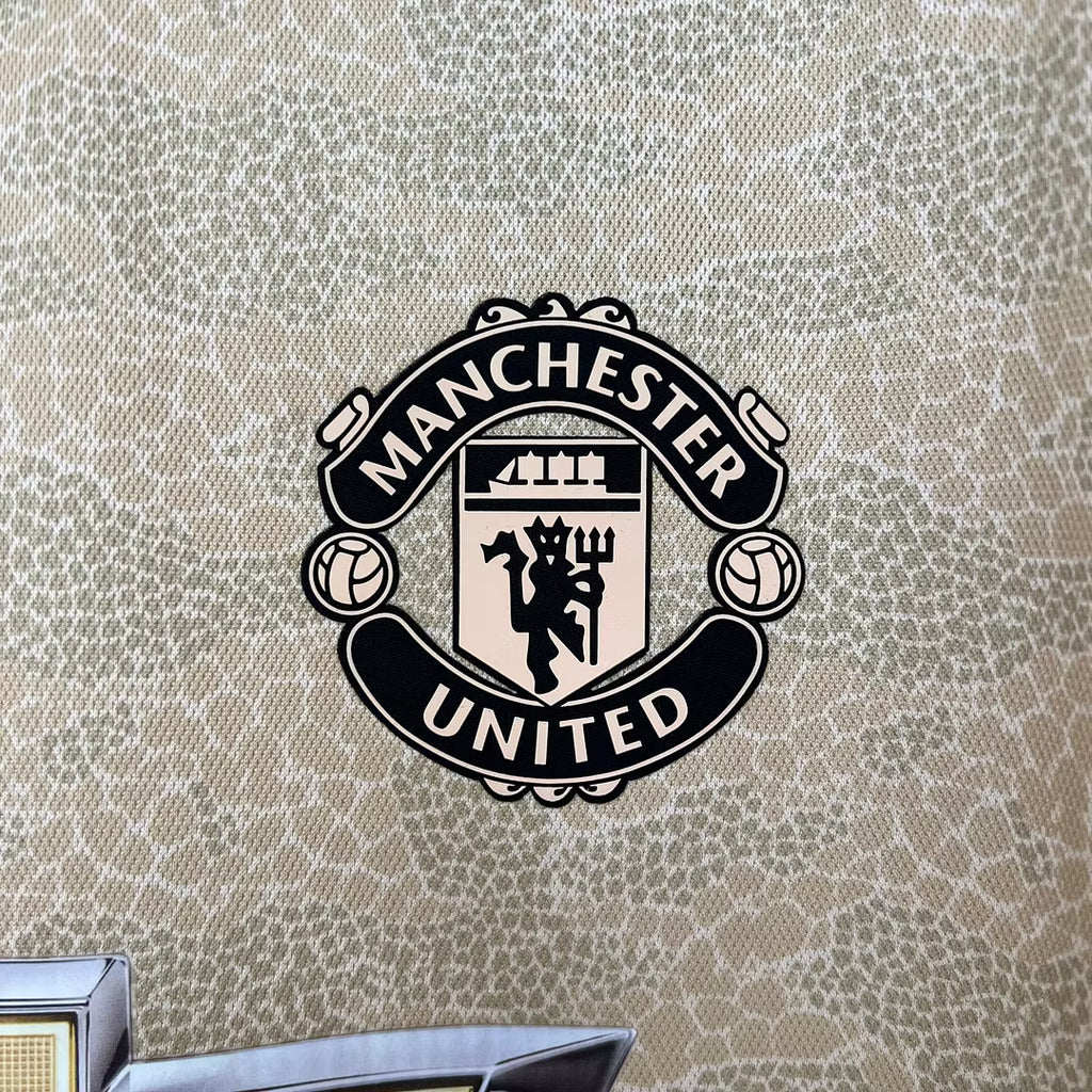 Manchester United crest patch on gold retro football jersey