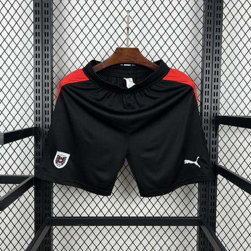Black soccer fan shorts with red side panels and Puma logo on hem