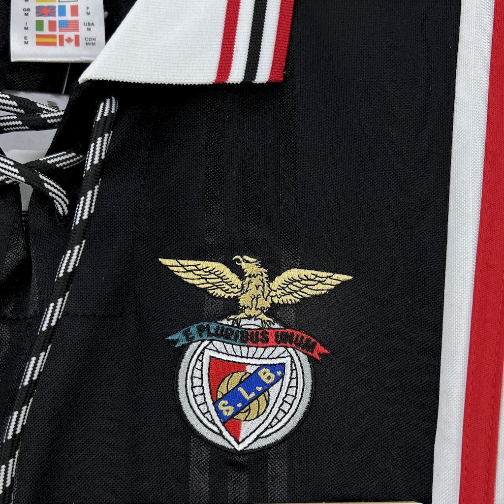 Black jersey chest shows Benfica crest with gold wings and red-and-green banner