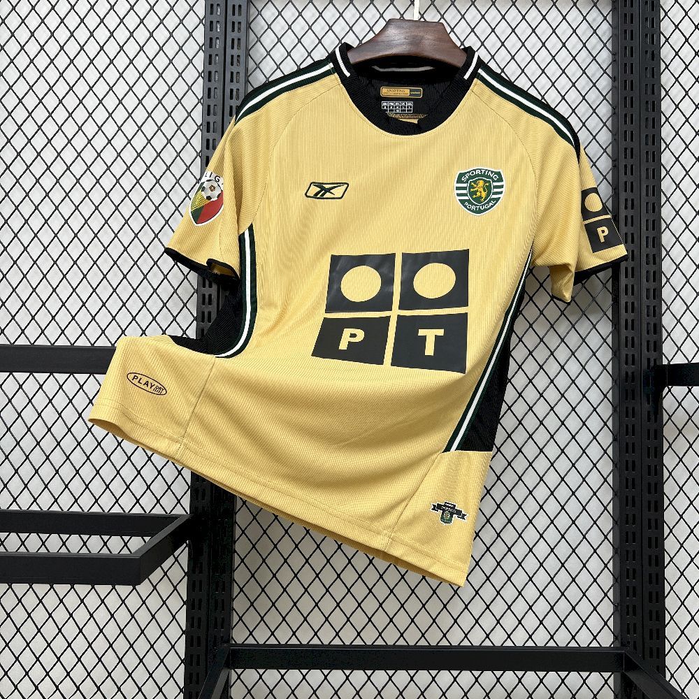 Yellow retro football jersey with black trim, green accents, club crest, geometric front logo