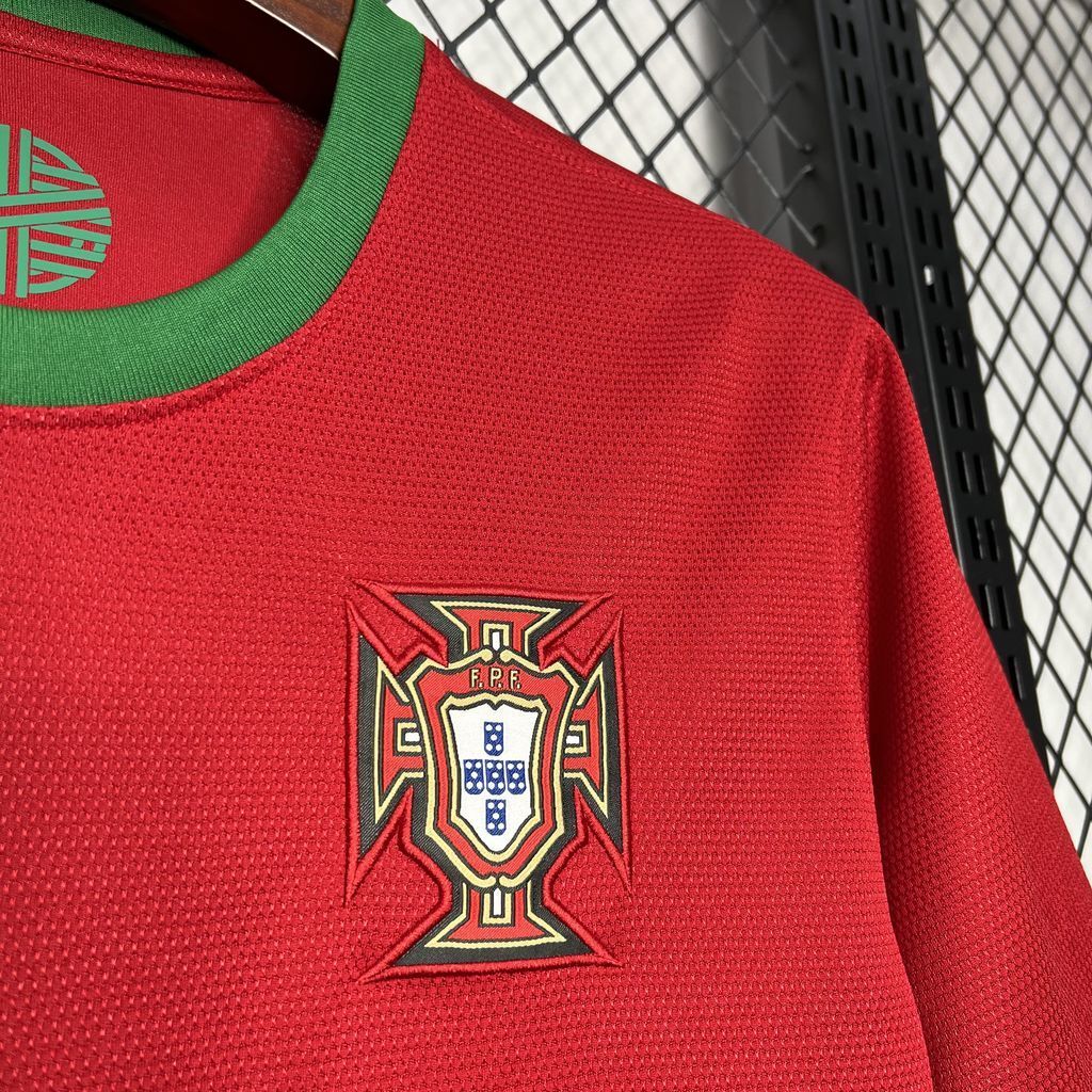 Red soccer jersey with embroidered Portugal crest on chest and green collar trim.