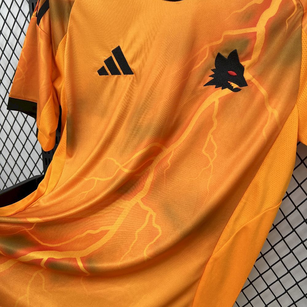 Orange soccer jersey close-up with adidas logo and team crest on lightning pattern