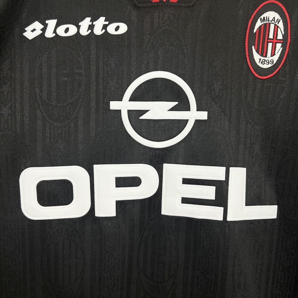 Black jersey front with lotto logo, Milan crest, and Opel sponsor