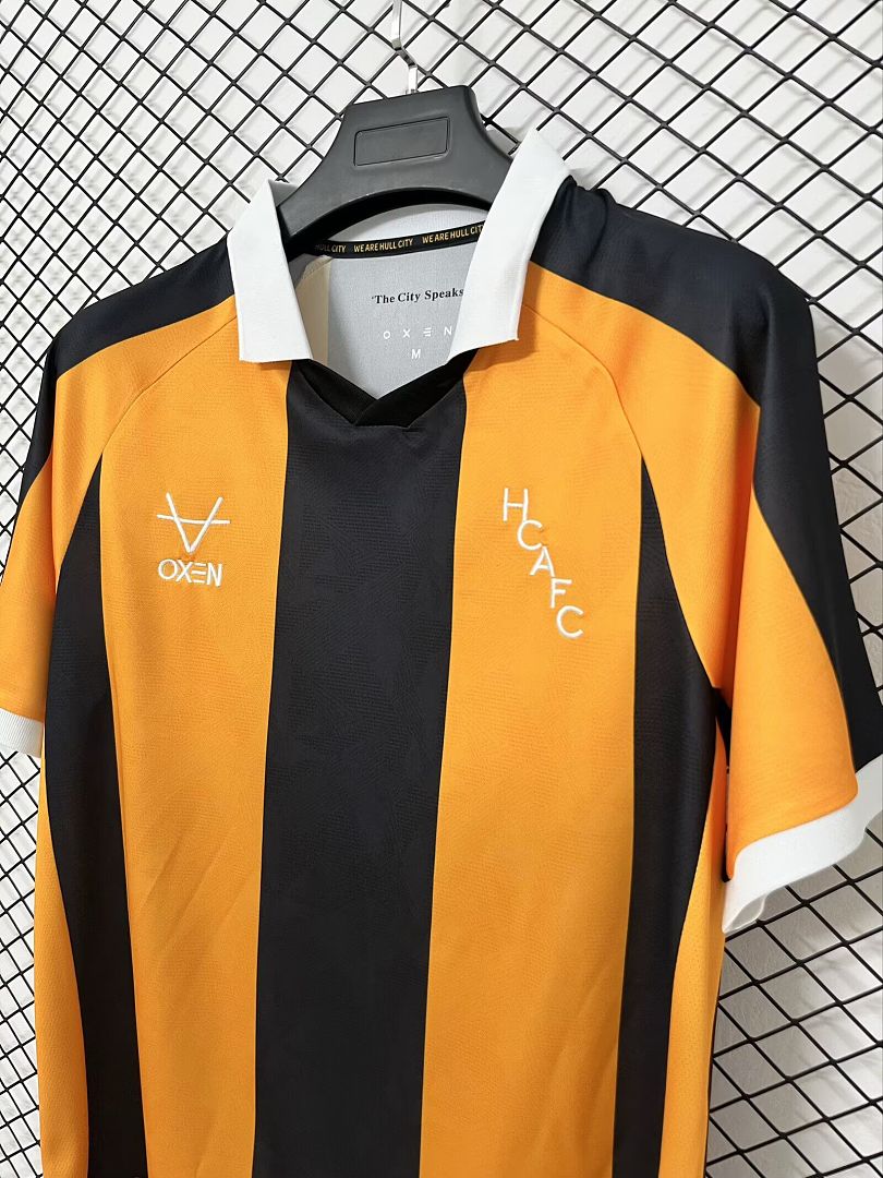 Home fan football shirt front with orange and black stripes, V-neck, OXEN and HcAFC logos