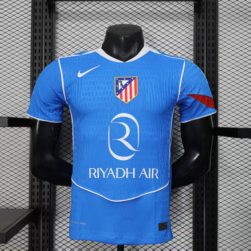 Blue third soccer jersey on mannequin, front with crest, Nike swoosh, RIYADH AIR sponsor.