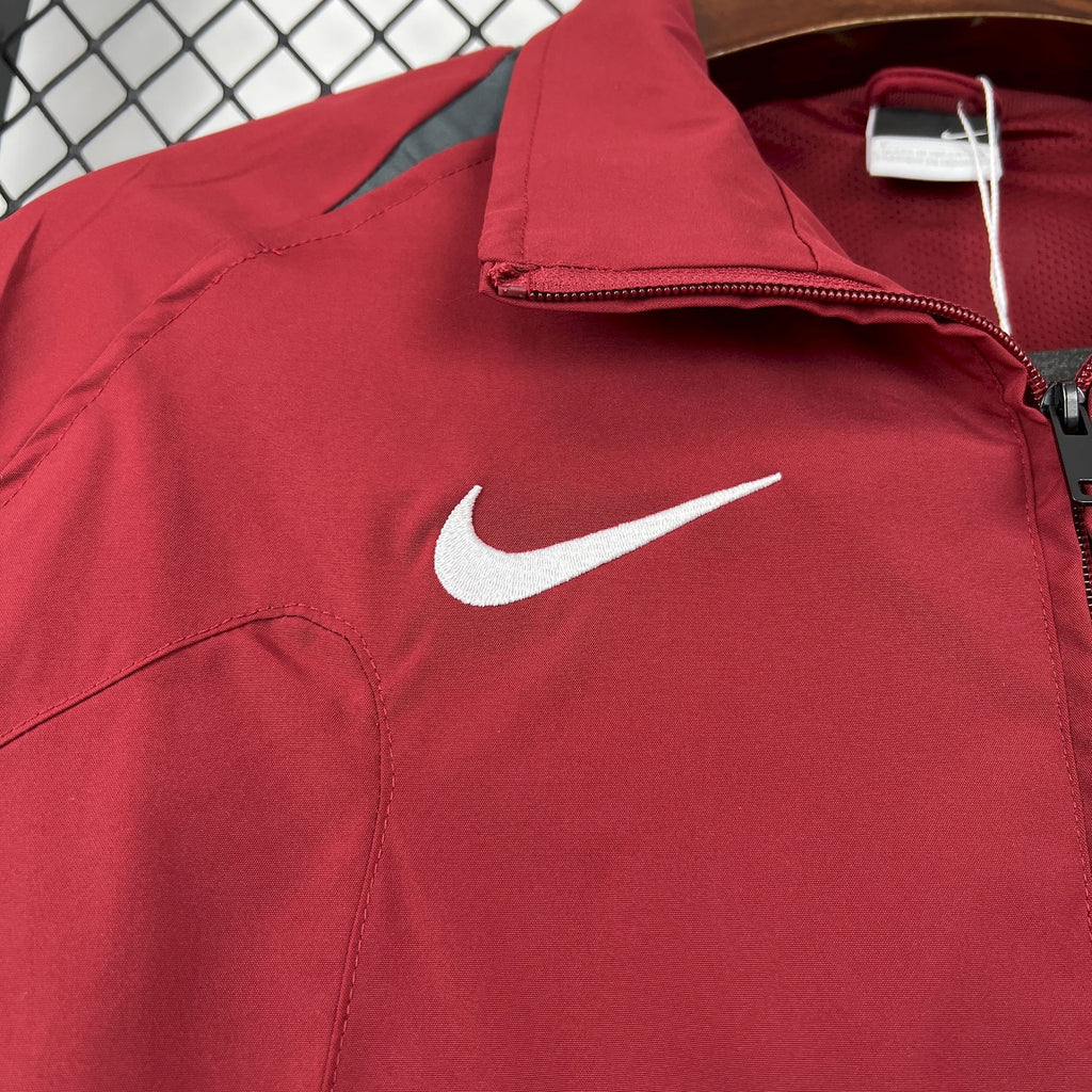 Red windbreaker jacket with Nike swoosh logo near shoulder and half-zip collar