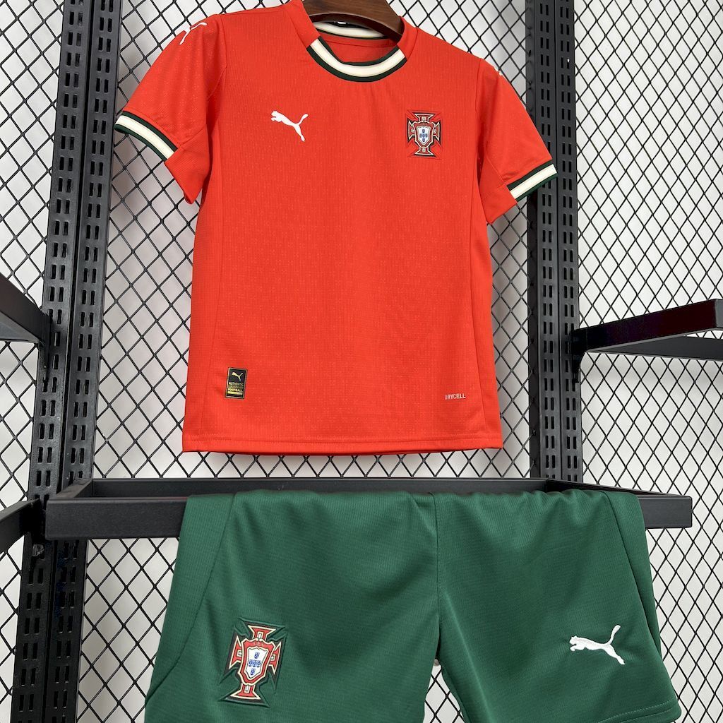 Red kids soccer jersey with striped trim, Puma logo, and green matching shorts