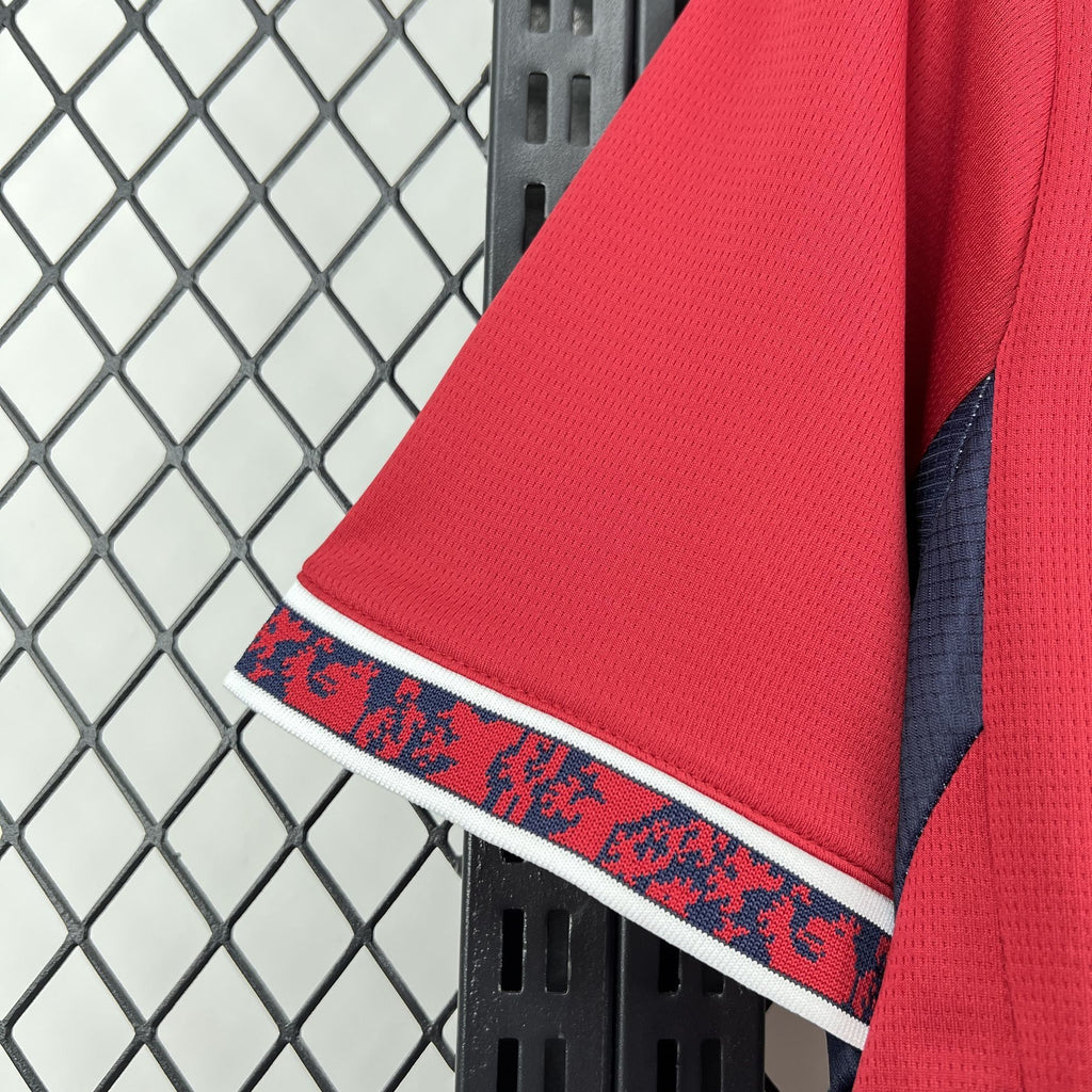 Red sleeve cuff with patterned blue-red stripe and white trim