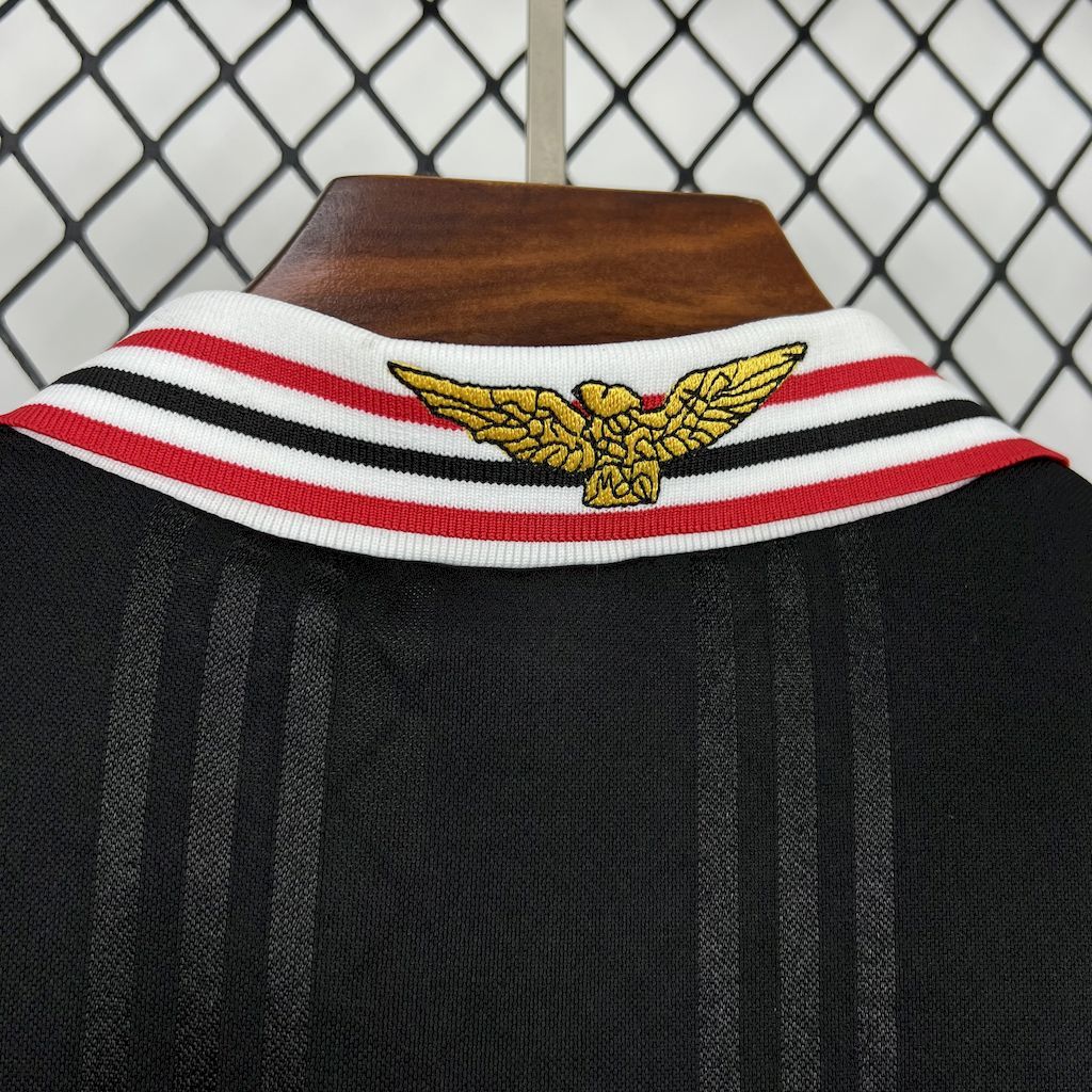 Black jersey collar with white-red striped trim and gold winged emblem