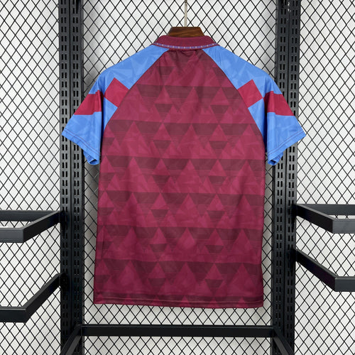 Maroon and light-blue retro home football shirt, back view with geometric panels