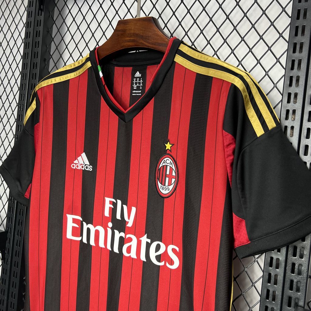 AC Milan home soccer jersey close-up with club crest, Fly Emirates, and yellow Adidas shoulder stripes