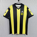 Black and yellow striped football jersey, V-neck, short sleeves with club crest