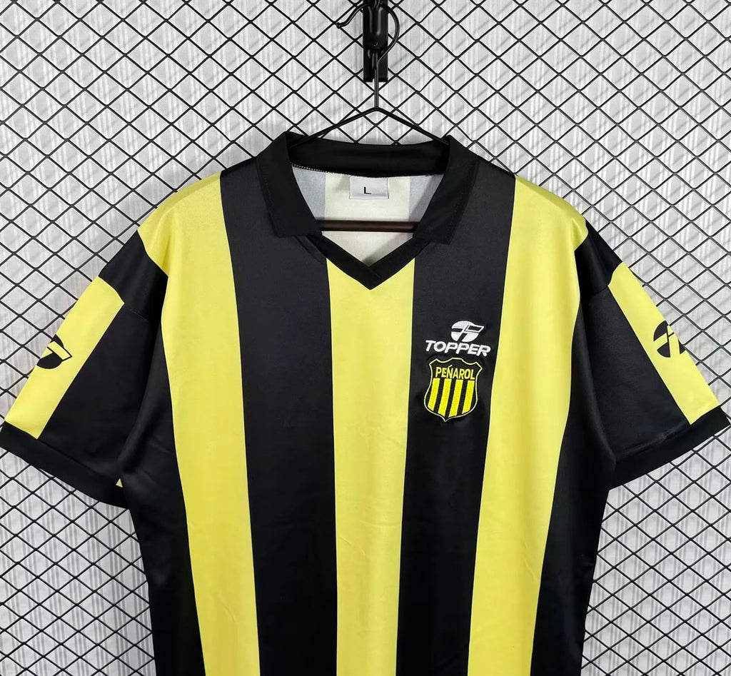 Black and yellow striped football jersey with V-neck and chest logos, short sleeves