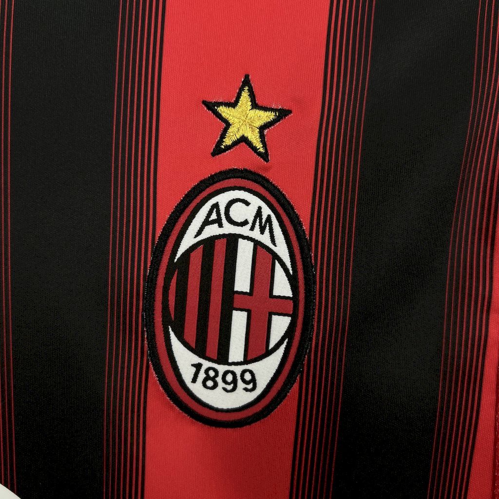 AC Milan oval crest with 1899 and star on red-and-black striped jersey