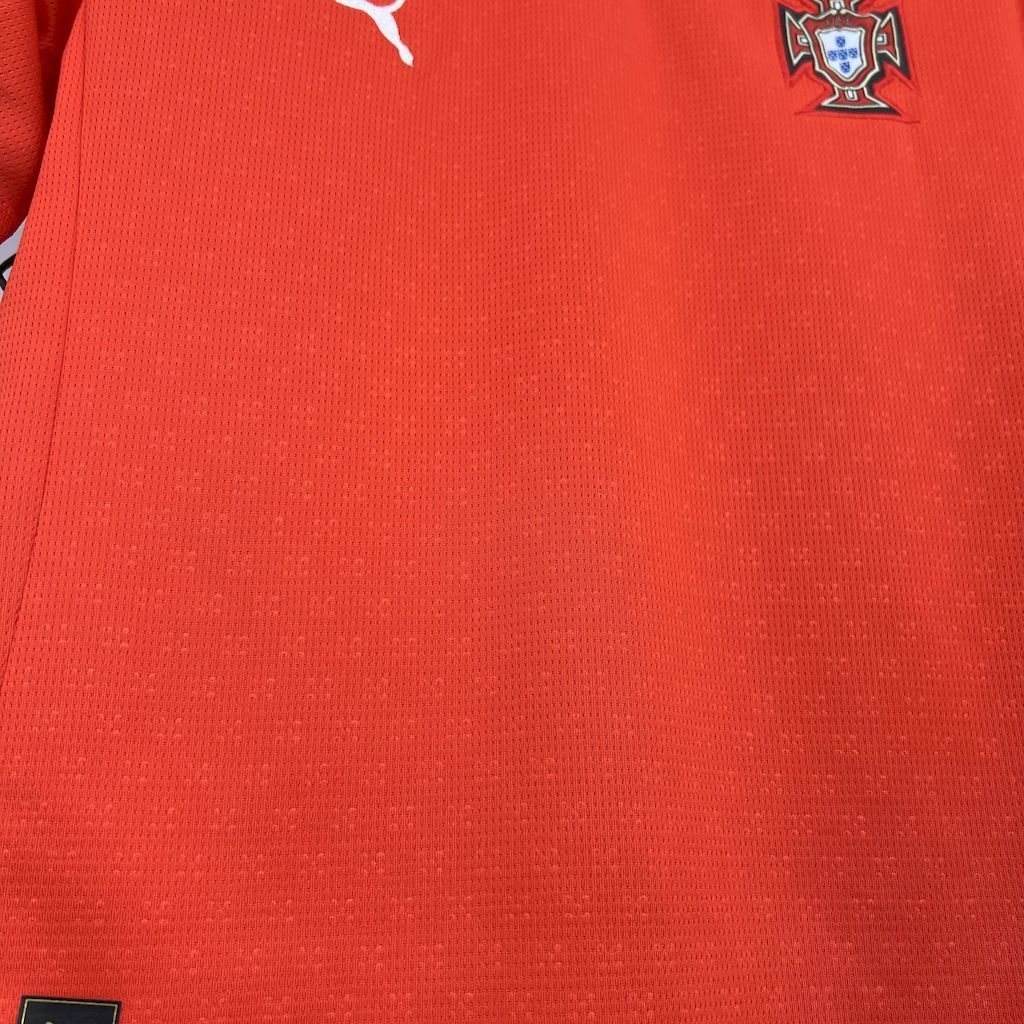 Red jersey fabric close-up with Portugal crest patch