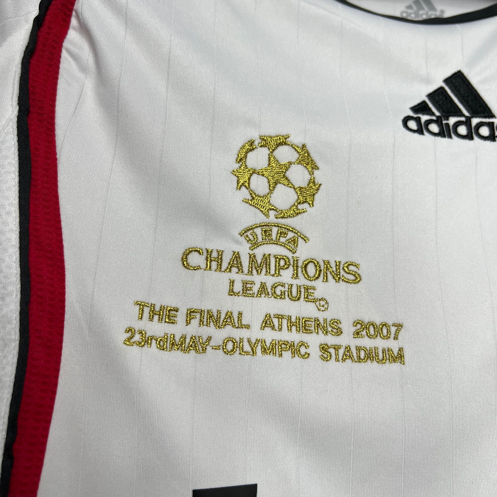 White away soccer jersey close-up: Champions League crest and adidas logo