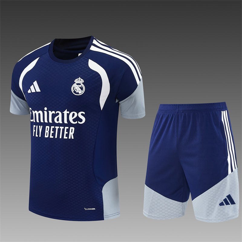 Real Madrid navy training shirt and shorts set with white stripes, logos.