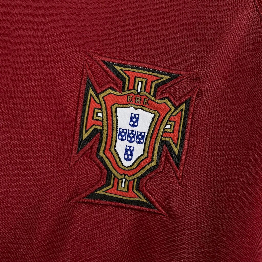 Maroon football jersey with team crest emblem on the chest