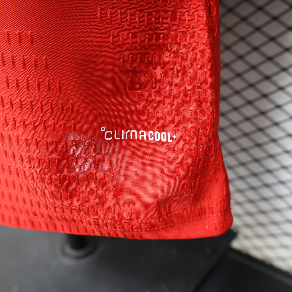 Arsenal home football jersey hem detail showing “clima cool+” on red knit