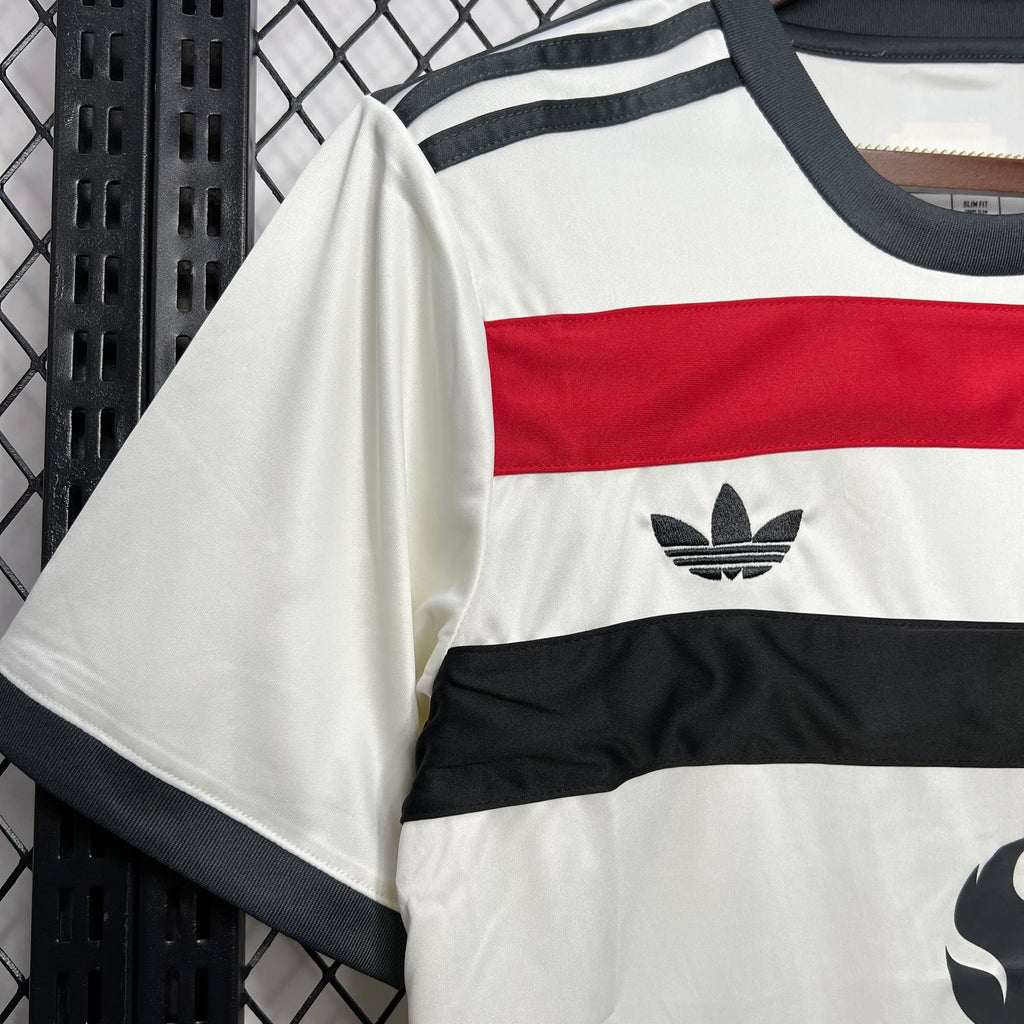 White third football jersey sleeve with navy collar and adidas-style logo