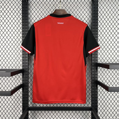 Red home football jersey with black sleeves, back view