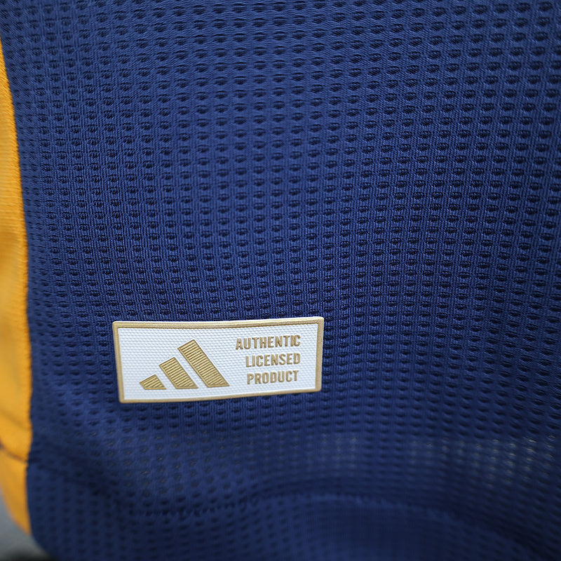 Blue jersey label reading AUTHENTIC LICENSED PRODUCT on textured fabric