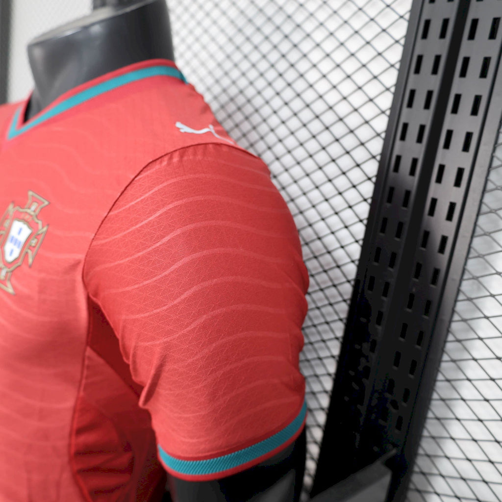 Red soccer jersey sleeve with teal cuff trim and Puma logo on side