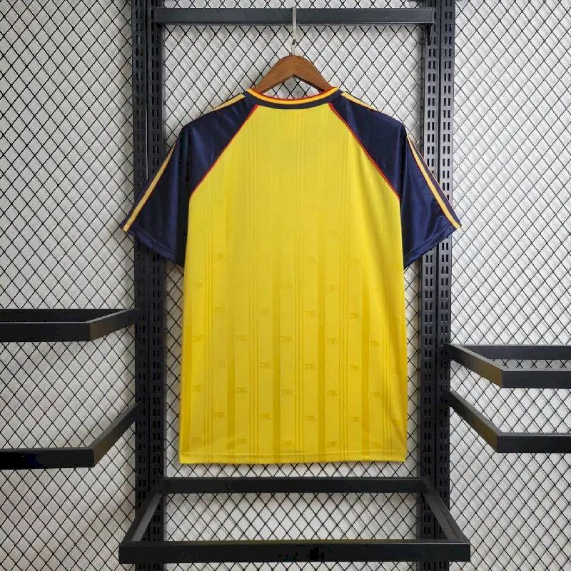 Front view yellow and navy retro football jersey with red trim and striped shoulders