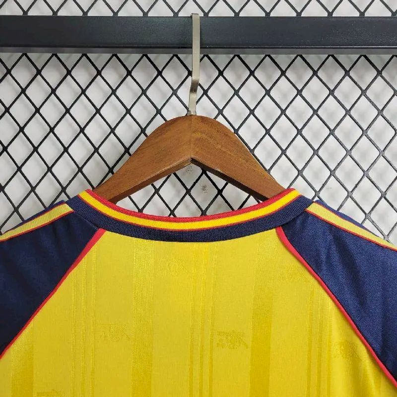 Retro football jersey neckline with navy collar, red and yellow trim stripes