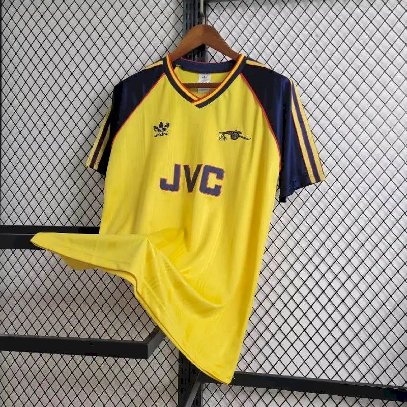 Yellow and navy retro football jersey with JVC logo, red trim, and striped cuffs