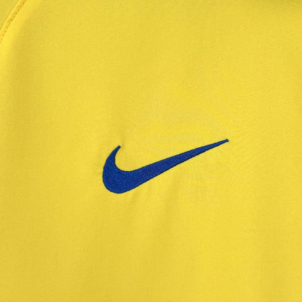 Yellow retro football jersey with blue Nike swoosh logo on chest