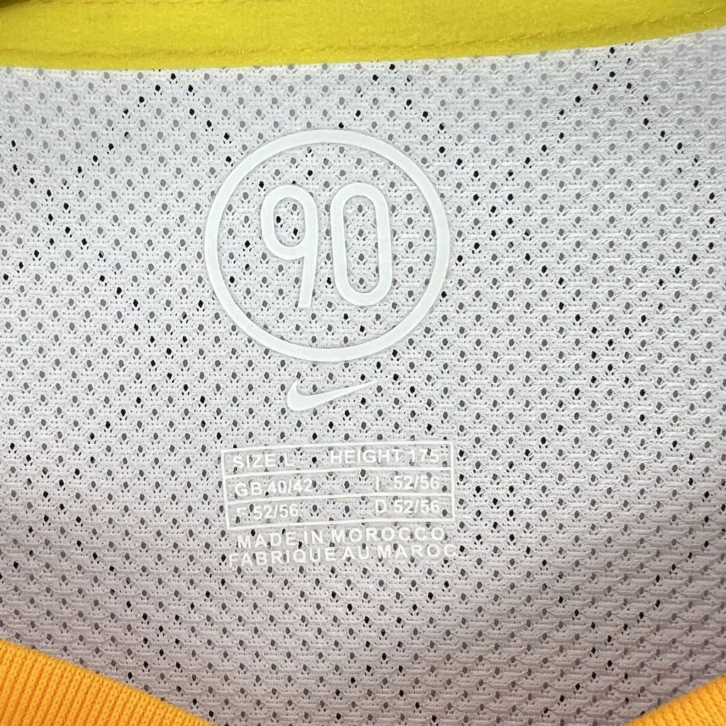 Soccer jersey label close-up: '90' marking, size text, and Made in Morocco print