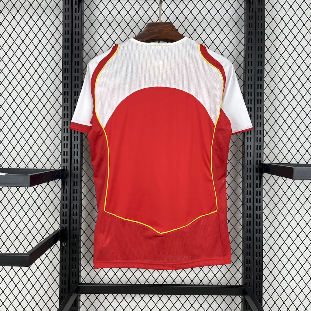 Red soccer jersey with yellow piping, large number graphic, and white sleeve panels