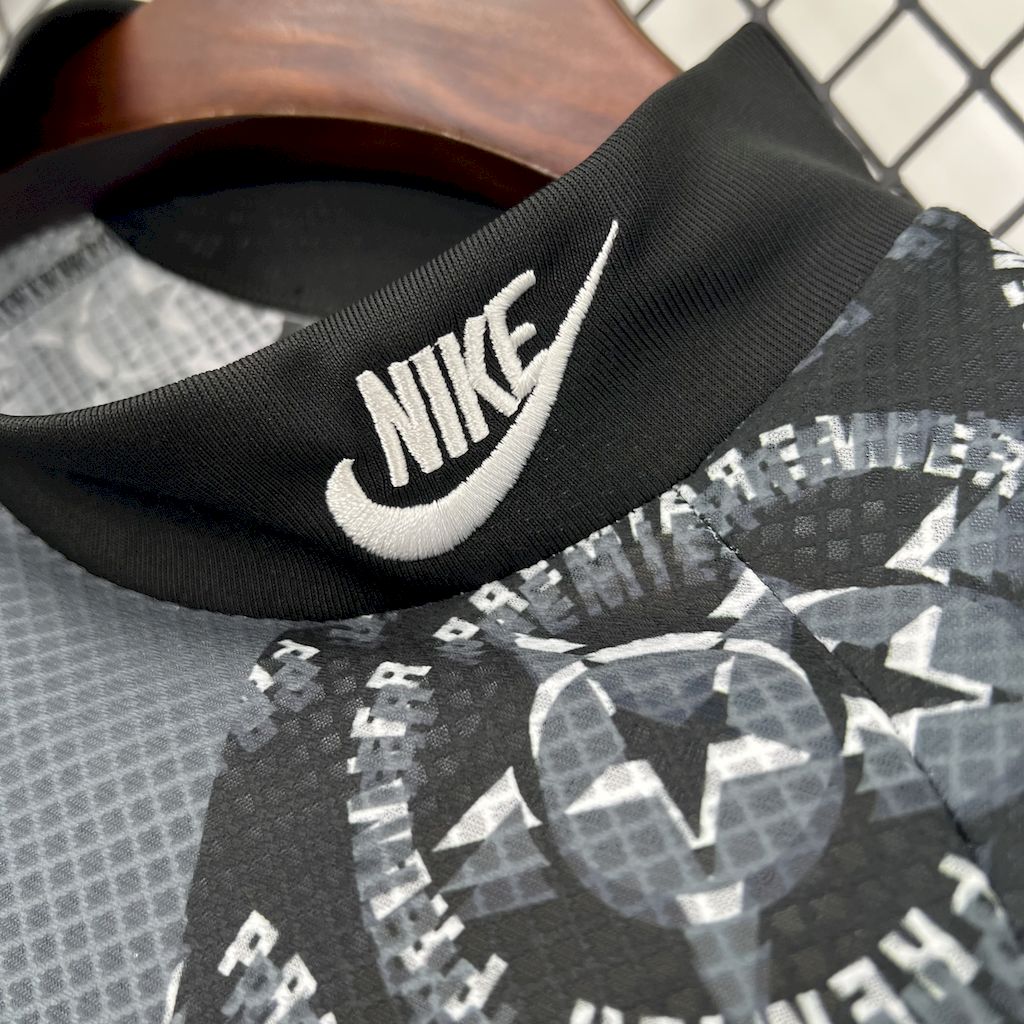 Nike swoosh on black goalkeeper jersey collar, with geometric pattern panels