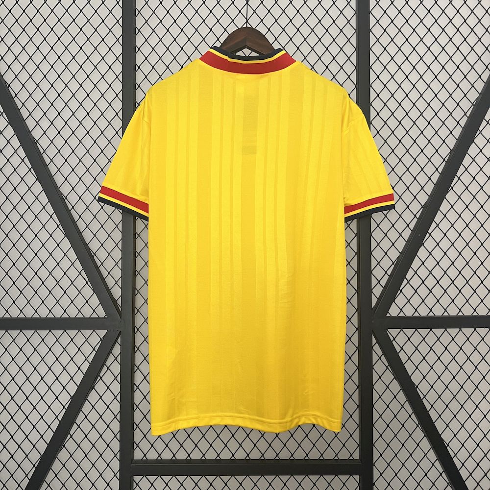 Yellow retro football jersey back with red-and-navy collar trim, no visible front sponsor